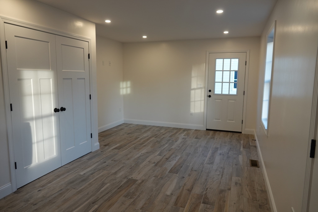 6 Pondover Road, Unit ADU Billerica, MA 01821 - Photo 4 of 20 an empty room with wooden floor and windows