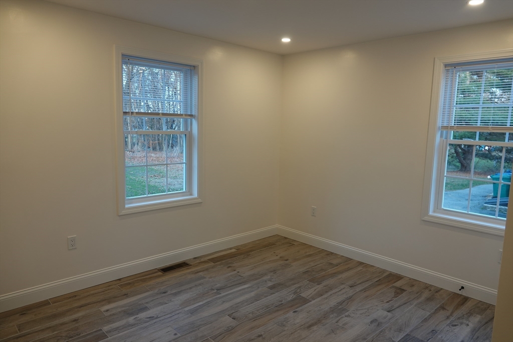 6 Pondover Road, Unit ADU Billerica, MA 01821 - Photo 6 of 20 an empty room with wooden floor and windows