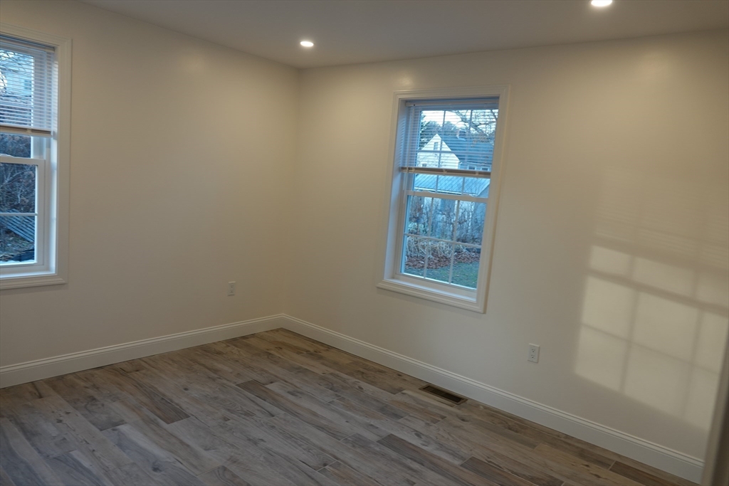 6 Pondover Road, Unit ADU Billerica, MA 01821 - Photo 8 of 20 an empty room with wooden floor and windows
