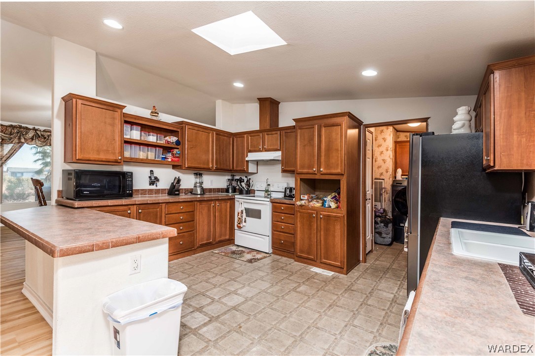 3321 West Rancho Road Golden Valley, AZ 86413 - Photo 38 of 50 a kitchen with stainless steel appliances granite countertop a refrigerator sink and cabinets