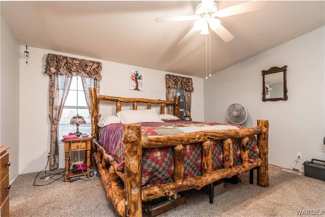 3321 West Rancho Road Golden Valley, AZ 86413 - Photo 6 of 50 a bed sitting in a bedroom next to a window