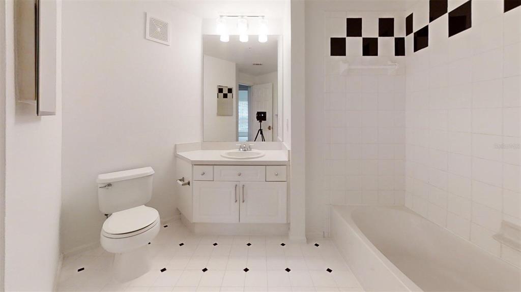 460 Water Street, Unit 460 Celebration, FL 34747 - Photo 12 of 38 a bathroom with a sink a toilet and a mirror