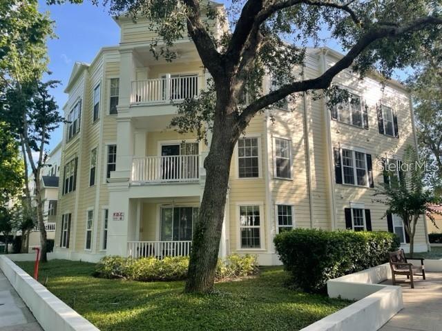 460 Water Street, Unit 460 Celebration, FL 34747 - Photo 2 of 38 a front view of a house with a yard