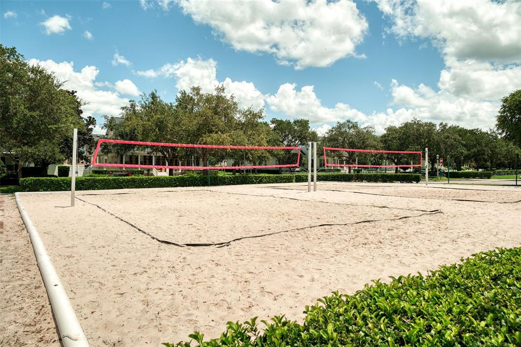 460 Water Street, Unit 460 Celebration, FL 34747 - Photo 33 of 38 a view of swimming pool with outdoor seating and trees in the background