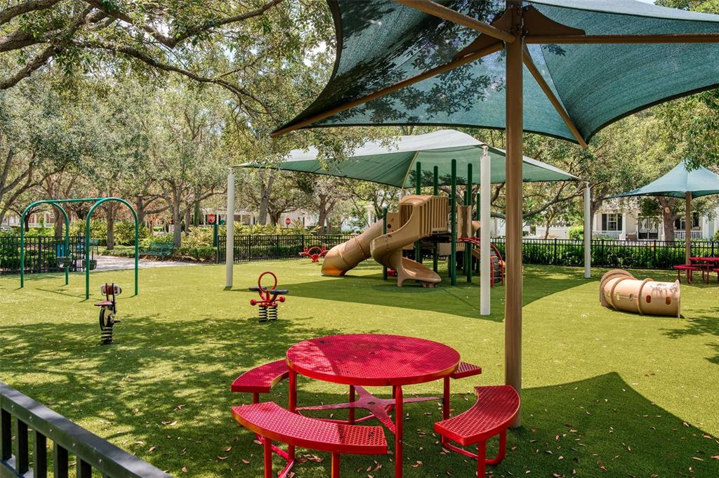 460 Water Street, Unit 460 Celebration, FL 34747 - Photo 34 of 38 an outdoor sitting area with furniture and umbrella