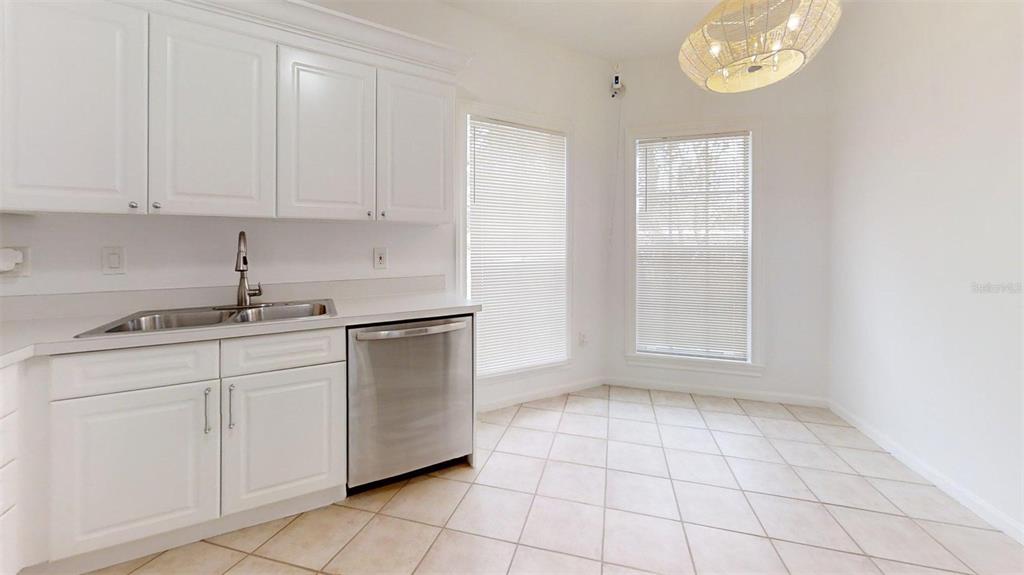 460 Water Street, Unit 460 Celebration, FL 34747 - Photo 6 of 38 a kitchen with a sink and cabinets