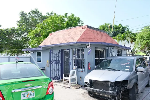 a aerial view of a house with a yard porch and furniture