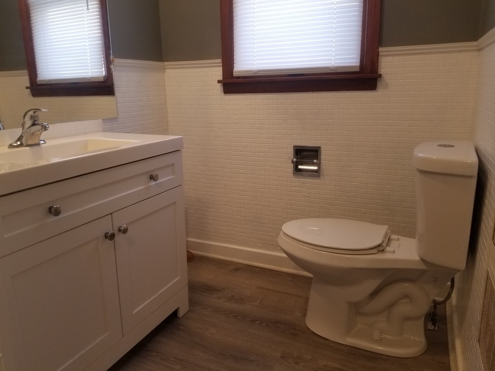 809 Calhoun Street Peru, IL 61354 - Photo 6 of 7 a bathroom with a toilet a sink a vanity and mirror