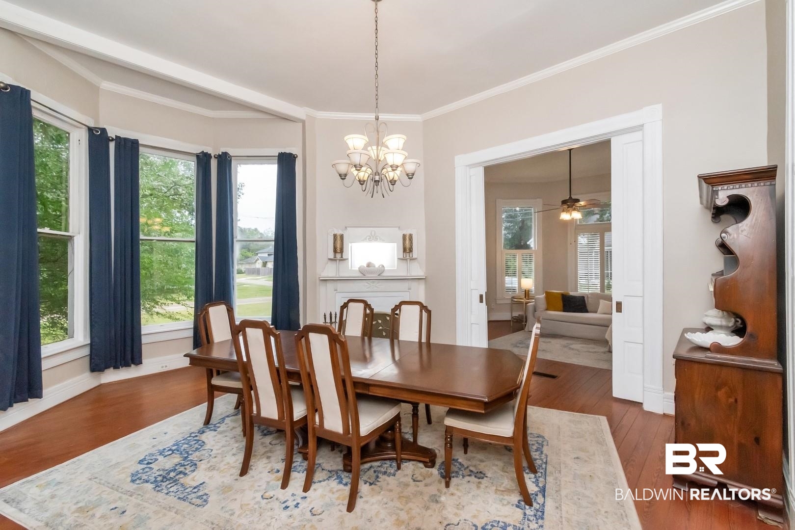 1305 Brown Street Mobile, AL 36604 - Photo 10 of 37 Dining area with ornamental molding, dark hardwood / wood-style floors, ceiling fan with notable chandelier, and a wealth of natural light