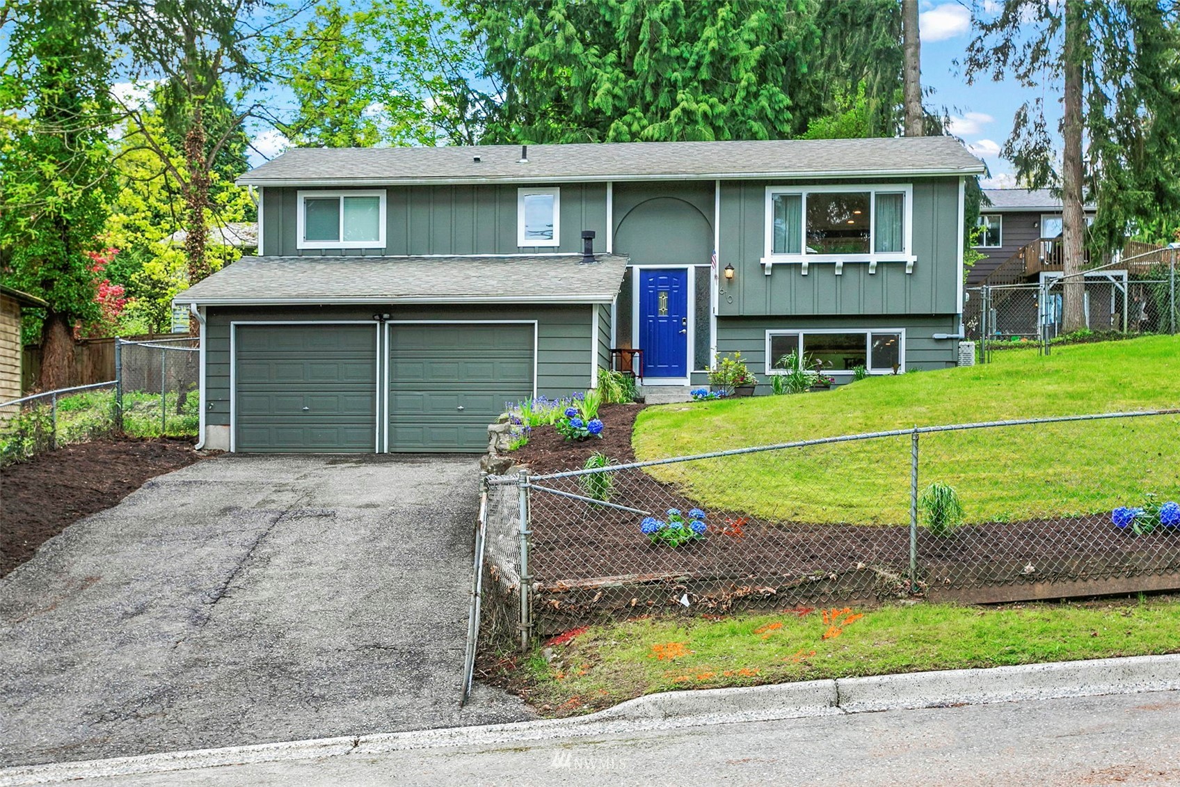 610 219th Place Southwest Bothell, WA 98021 - Photo 2 of 25 a front view of a house with a yard and garage