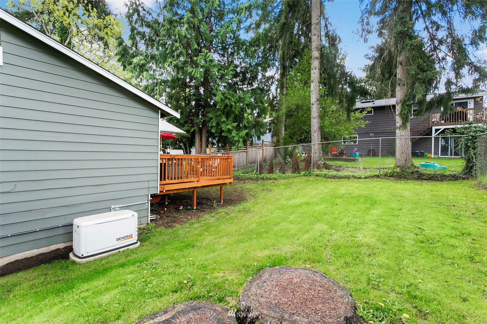 610 219th Place Southwest Bothell, WA 98021 - Photo 24 of 25 a backyard of a house with table and chairs