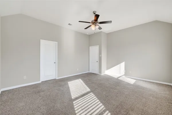 a view of a room with a ceiling fan