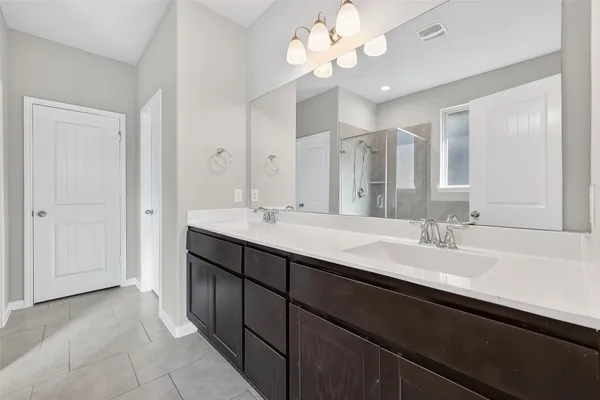 a bathroom with a sink vanity and a mirror