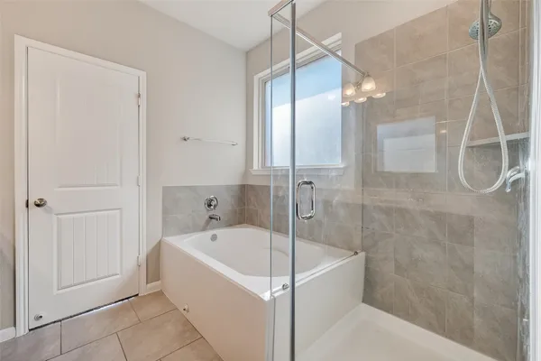 a white bath tub sitting next to a shower