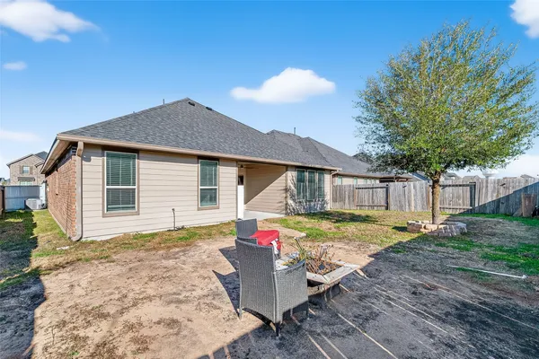 a view of a house with backyard and sitting area