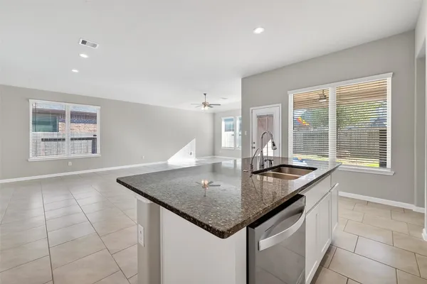 a kitchen with granite countertop a sink and a window