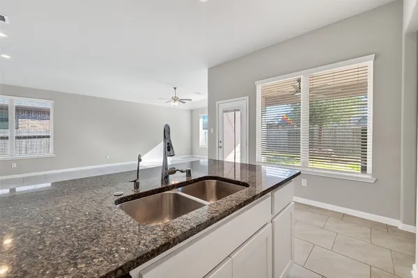 a kitchen with a sink cabinets and window