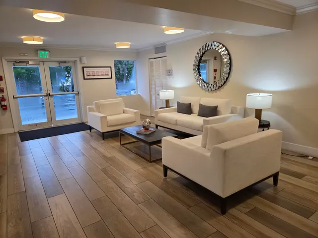 a living room with furniture and a clock