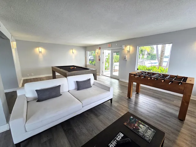 a living room with furniture and large windows