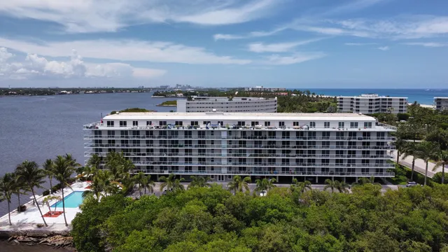 a view of a large building with a yard in the back