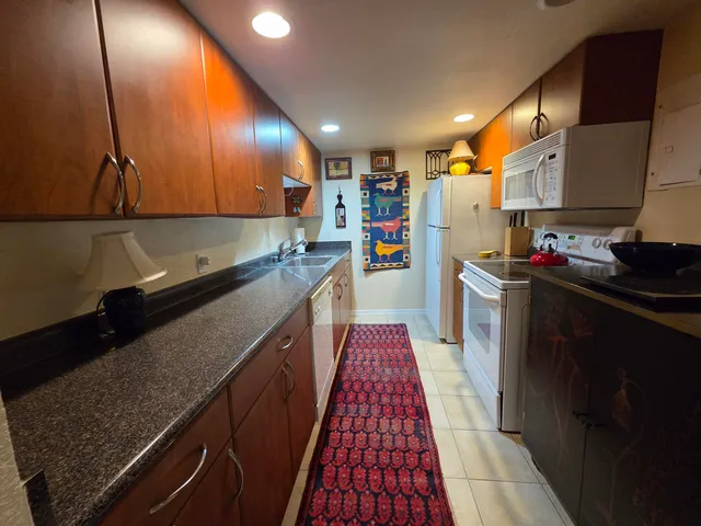 a kitchen with stainless steel appliances granite countertop sink stove and cabinets