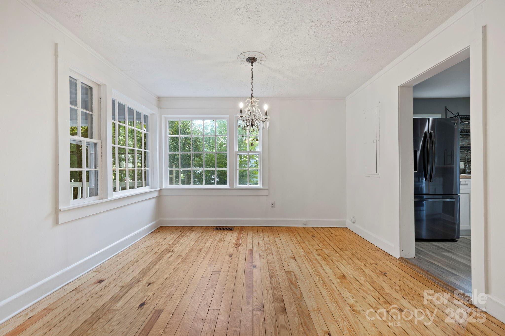 21 Maple Street Brevard, NC 28712 - Photo 16 of 29 a view of empty room with wooden floor and fan