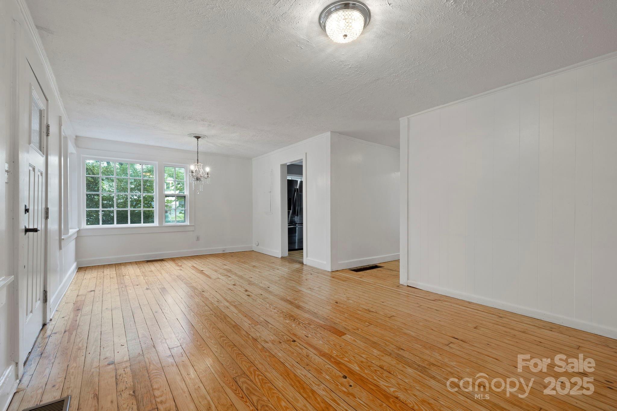 21 Maple Street Brevard, NC 28712 - Photo 17 of 29 a view of an empty room with wooden floor and a window