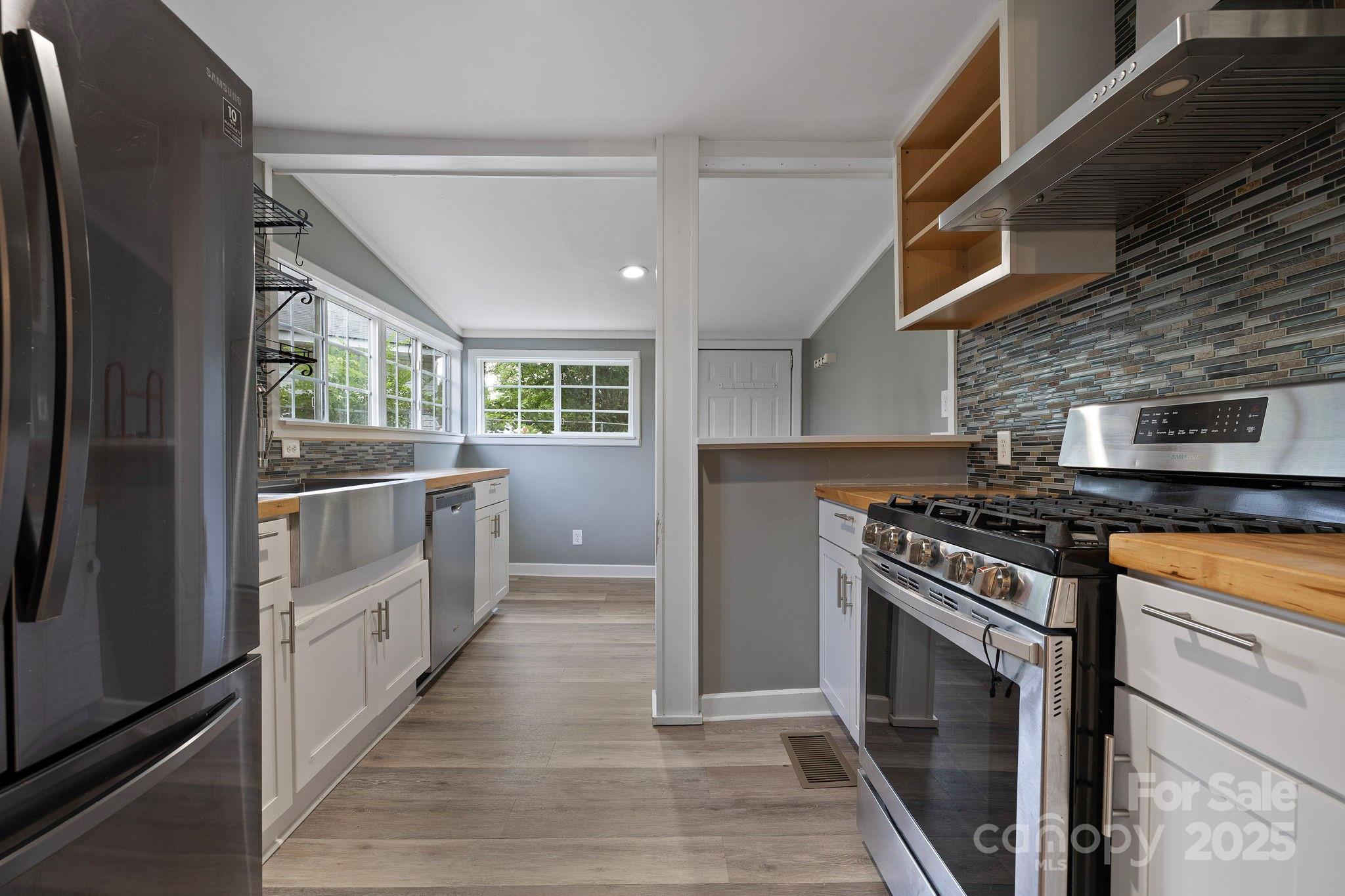 21 Maple Street Brevard, NC 28712 - Photo 18 of 29 a kitchen with stainless steel appliances granite countertop a stove and a refrigerator