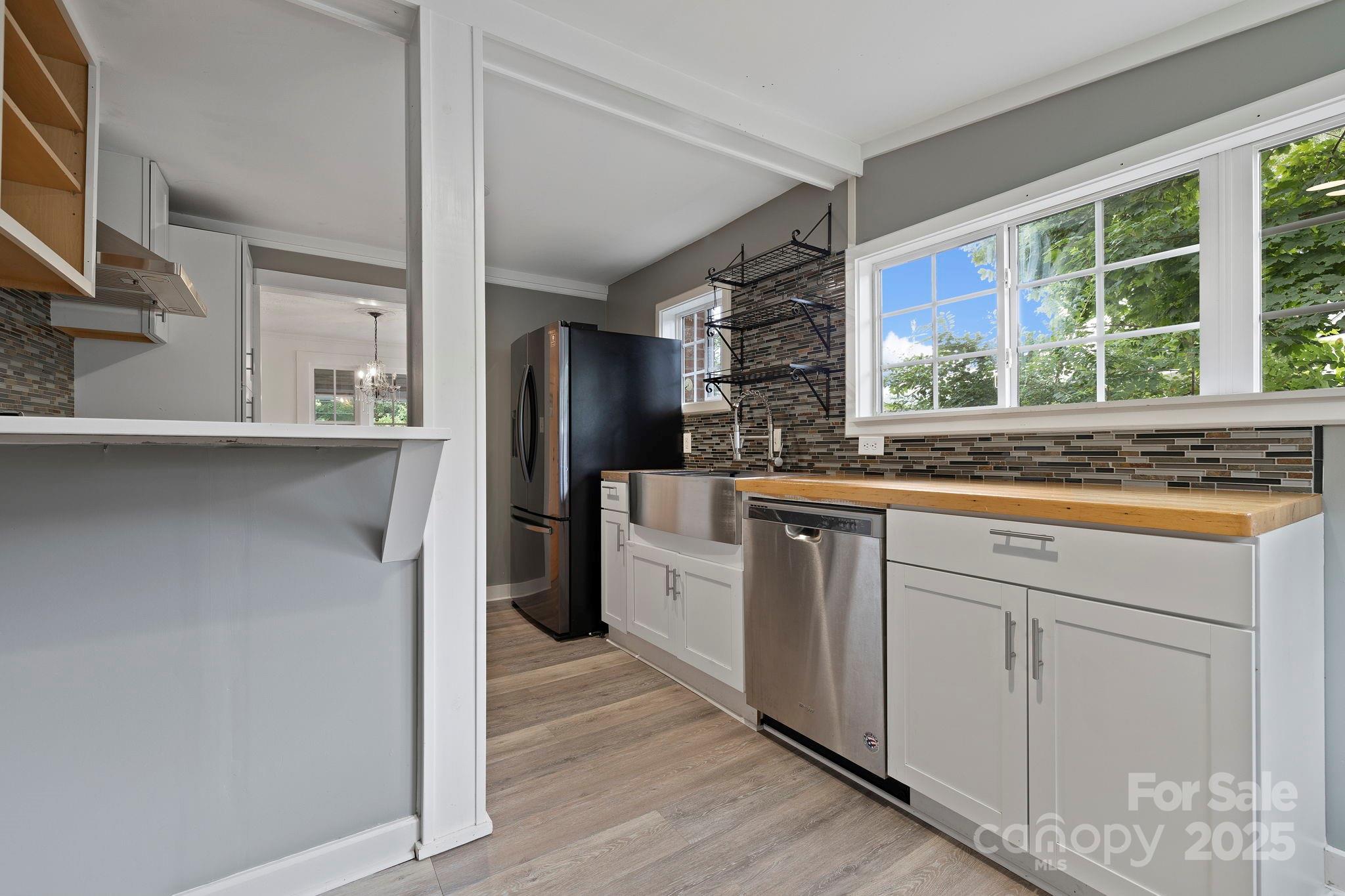 21 Maple Street Brevard, NC 28712 - Photo 20 of 29 a kitchen with stainless steel appliances a refrigerator and a stove