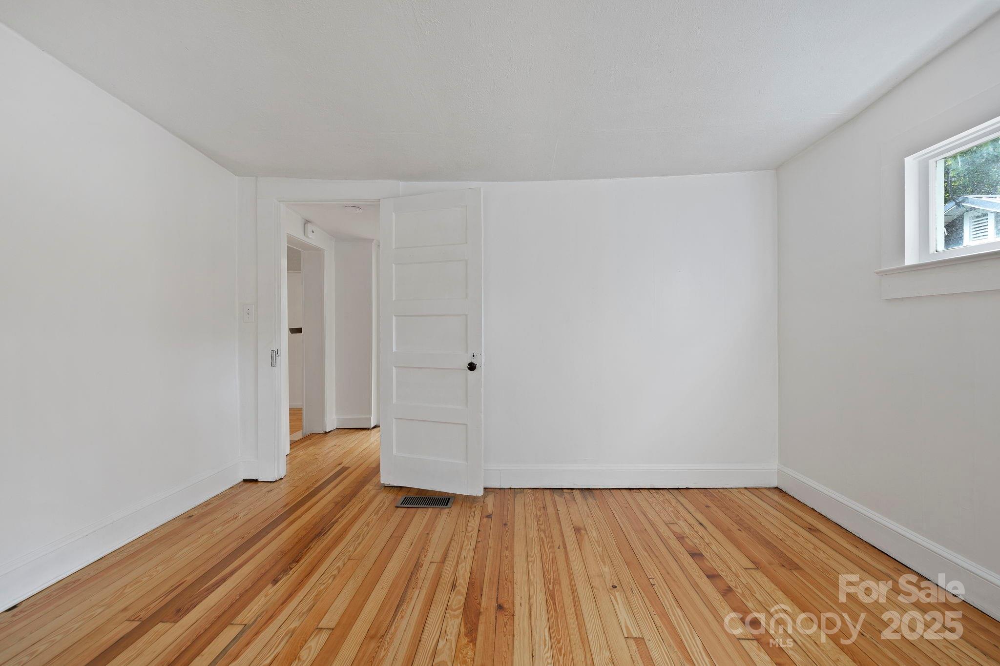 21 Maple Street Brevard, NC 28712 - Photo 26 of 29 a view of an empty room with wooden floor and a window