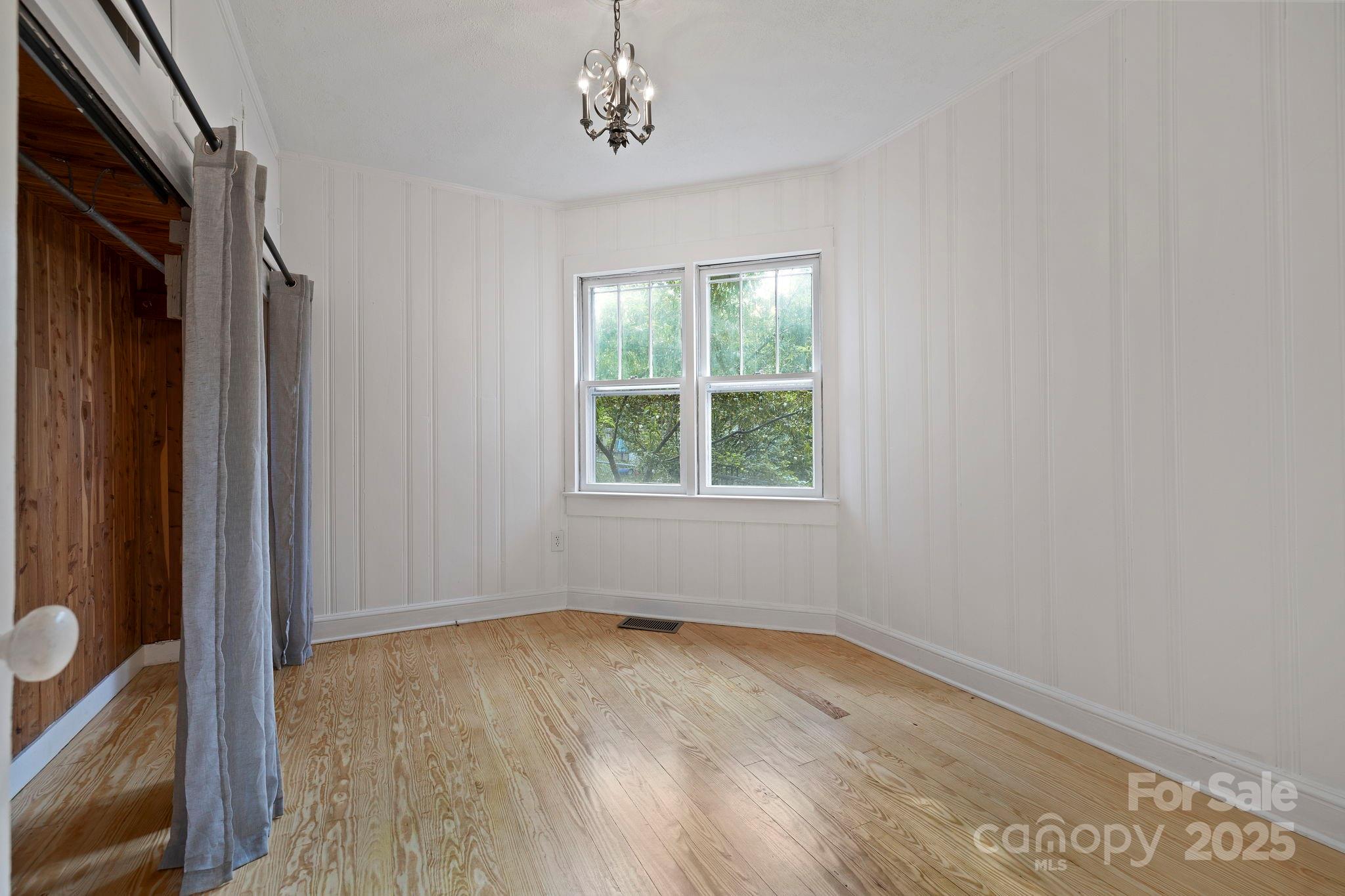 21 Maple Street Brevard, NC 28712 - Photo 27 of 29 a view of empty room with wooden floor and fan