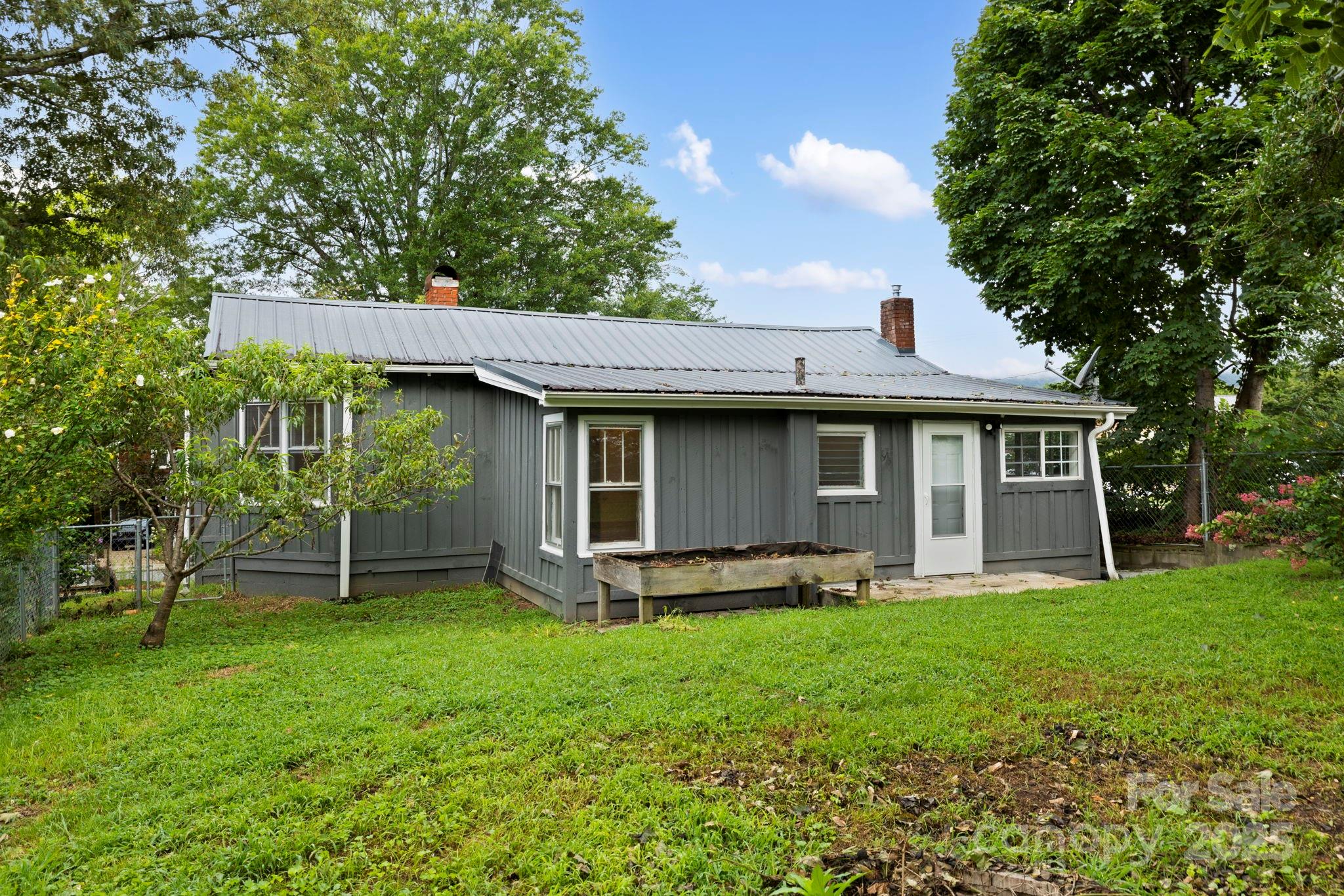 21 Maple Street Brevard, NC 28712 - Photo 9 of 29 a front view of a house with a yard and trees