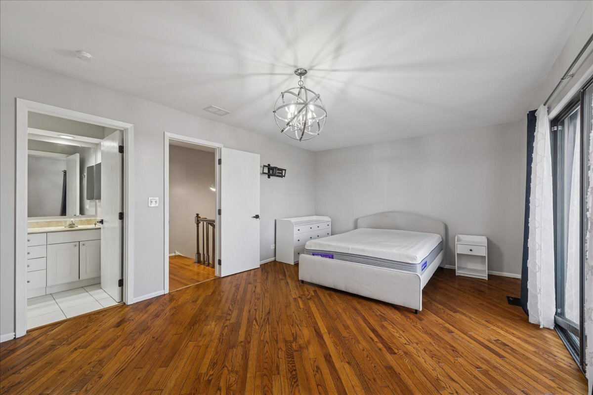 3120 Antelope Springs Road Northbrook, IL 60062 - Photo 14 of 27 a bedroom with a bed and wooden floor