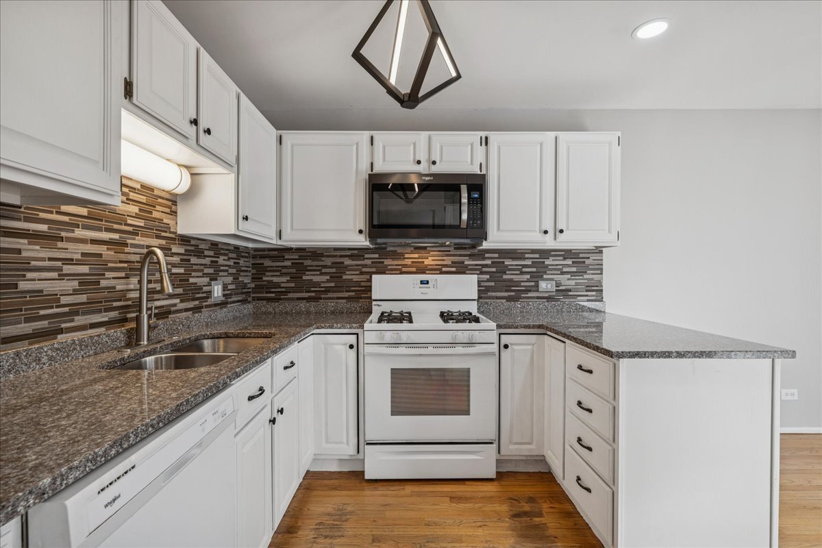 3120 Antelope Springs Road Northbrook, IL 60062 - Photo 7 of 27 a kitchen with stainless steel appliances granite countertop a sink a stove a microwave and cabinets