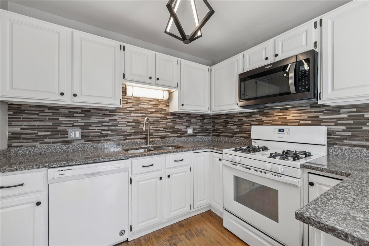 3120 Antelope Springs Road Northbrook, IL 60062 - Photo 8 of 27 a kitchen with white cabinets stainless steel appliances and sink
