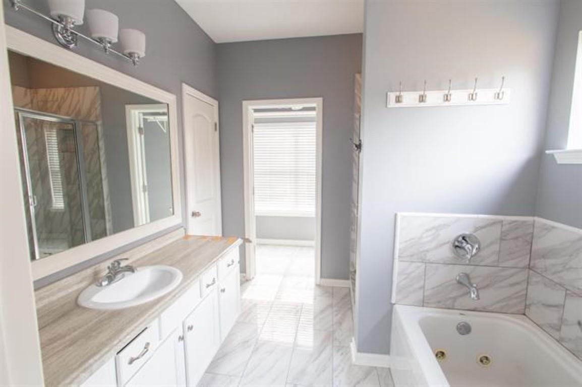 3430 Roxee Run Cove Bartlett, TN 38133 - Photo 13 of 32 a bathroom with a tub sink and mirror