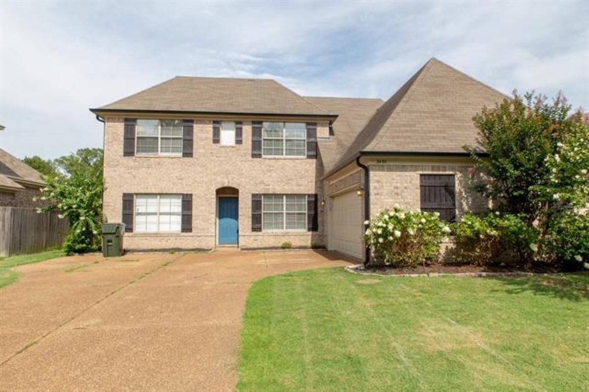 3430 Roxee Run Cove Bartlett, TN 38133 - Photo 30 of 32 a front view of a house with a garden