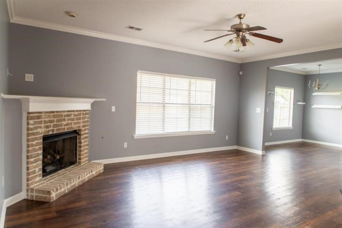 3430 Roxee Run Cove Bartlett, TN 38133 - Photo 3 of 32 an empty room with wooden floor fireplace and windows