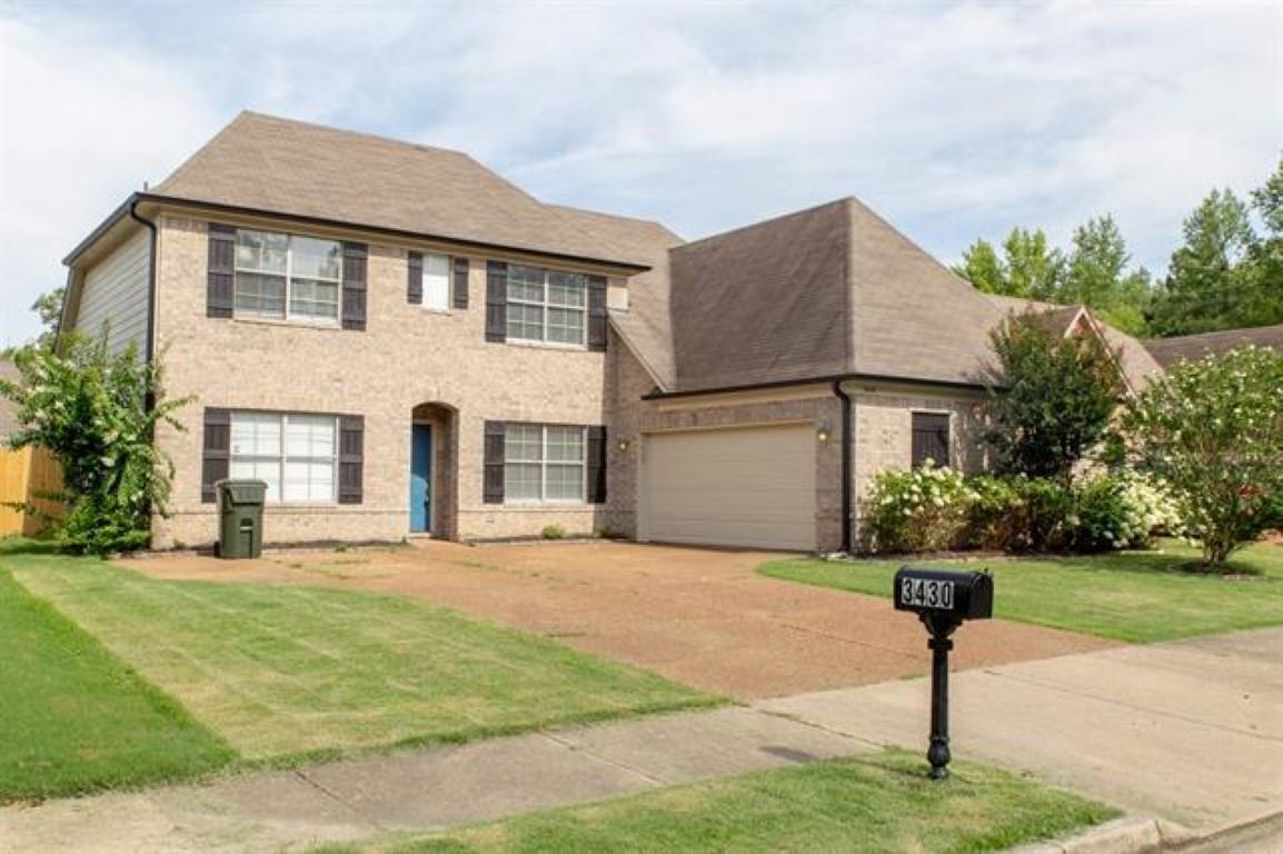 3430 Roxee Run Cove Bartlett, TN 38133 - Photo 31 of 32 a front view of a house with a yard and garage