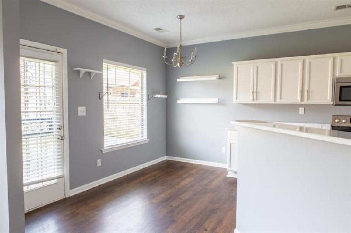 3430 Roxee Run Cove Bartlett, TN 38133 - Photo 6 of 32 a view of an empty room with a window and wooden floor
