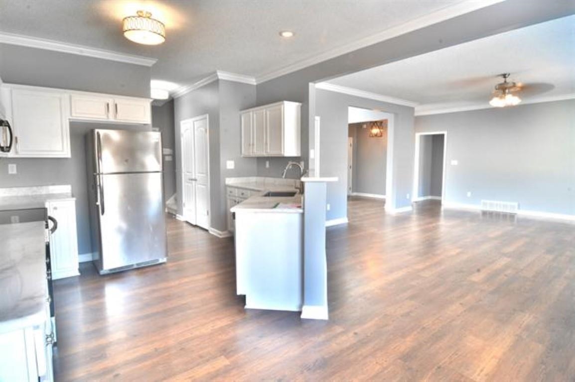 3430 Roxee Run Cove Bartlett, TN 38133 - Photo 8 of 32 a view of a kitchen with refrigerator and wooden floor