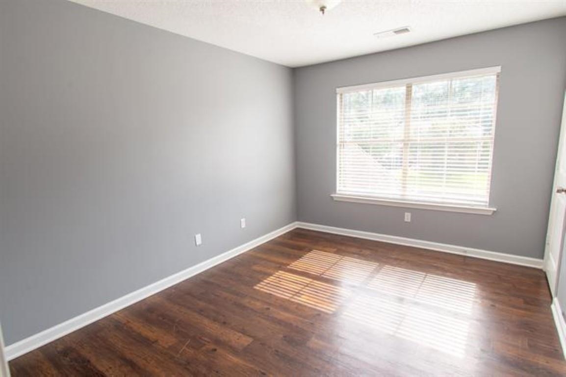 3430 Roxee Run Cove Bartlett, TN 38133 - Photo 9 of 32 a view of an empty room with wooden floor and a window