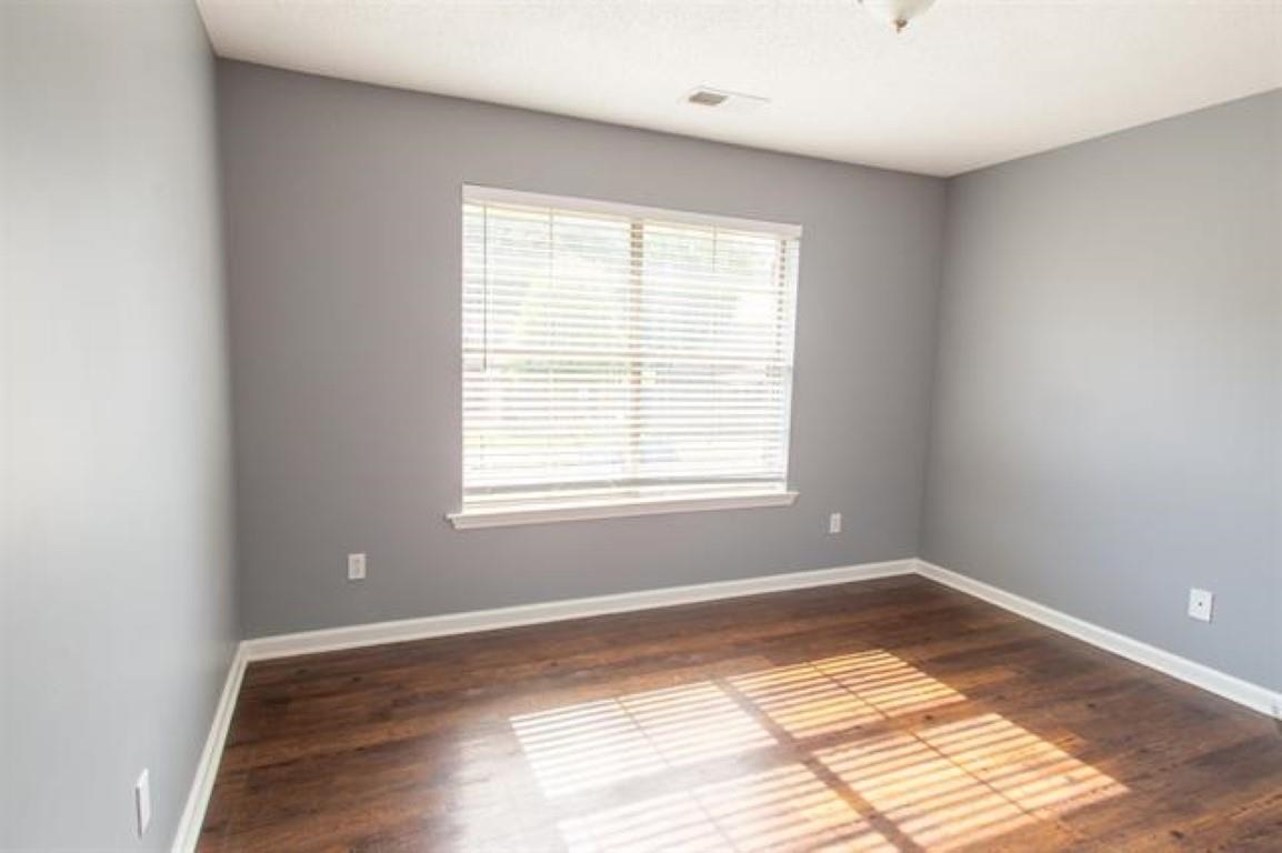 3430 Roxee Run Cove Bartlett, TN 38133 - Photo 10 of 32 a view of an empty room with wooden floor and a window