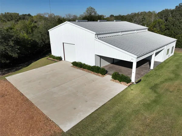 an aerial view of a house with a yard and garage