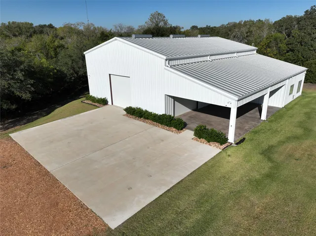 an aerial view of a house with a yard and garage
