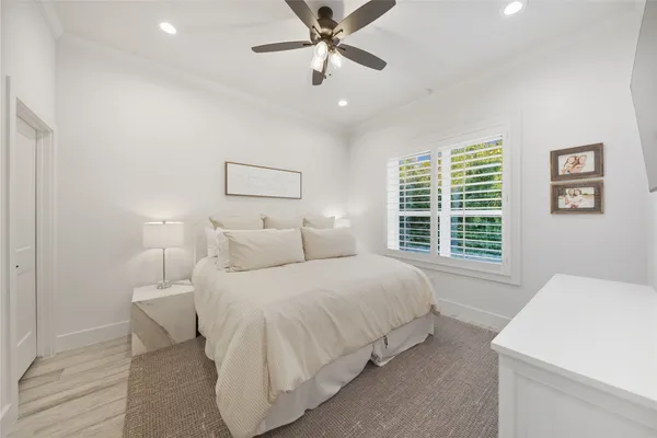 a bedroom with a large bed and a chandelier