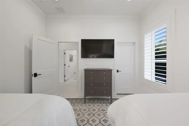 a bedroom with a bed and a flat screen tv