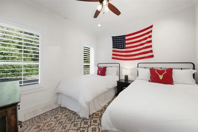 a bedroom with two beds and a window