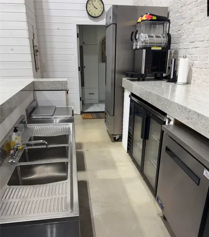 a kitchen with a refrigerator and a stove