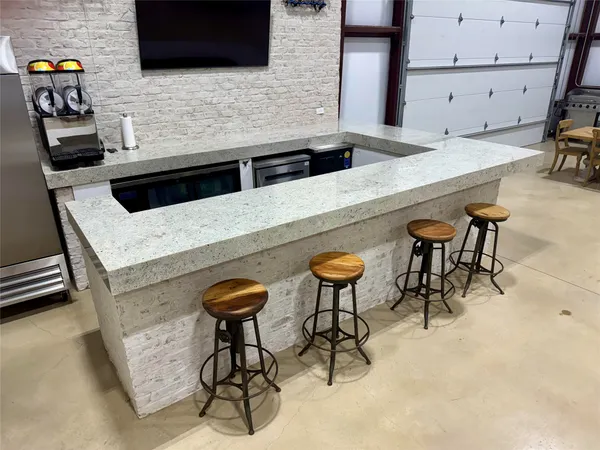 a kitchen with stainless steel appliances kitchen island a stove and a microwave